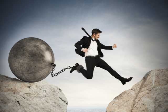 Businessman jumping obstacles
