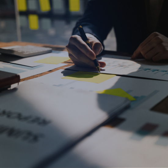 a man hand writing down tasks on a papet and post it notes yellow