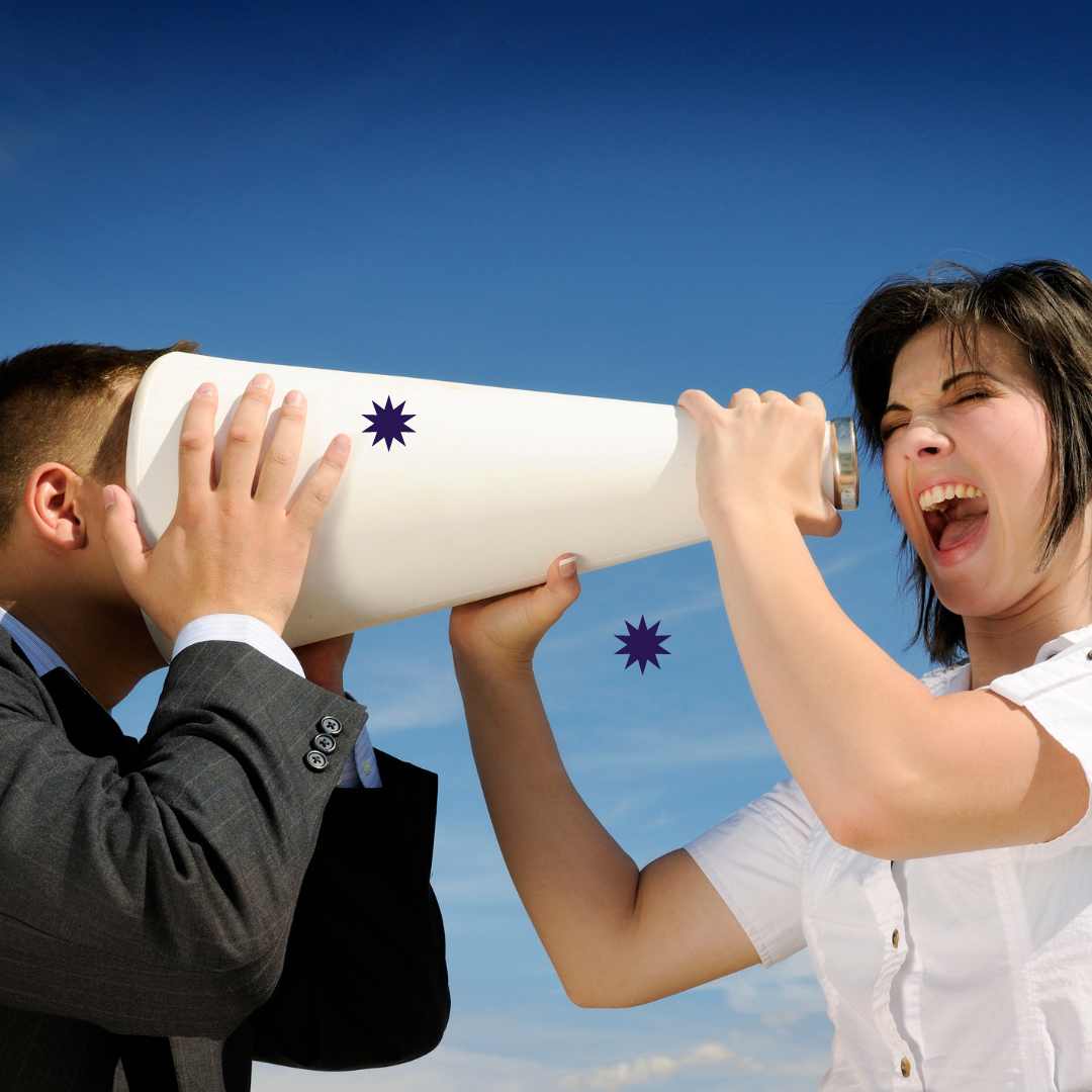 A woman is shouting on a manager trough megaphone, and his head is in there